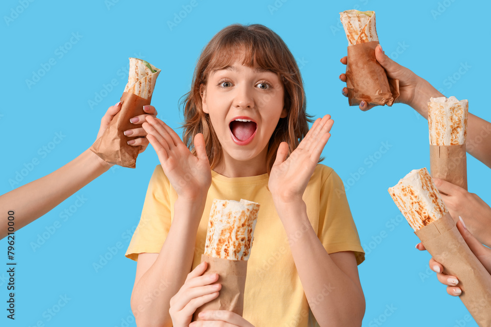 Poster surprised young woman and hands with doner kebabs on blue background