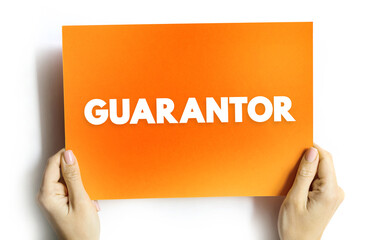 Guarantor - a person or thing that gives or acts as a guarantee, text concept on card - 796215427