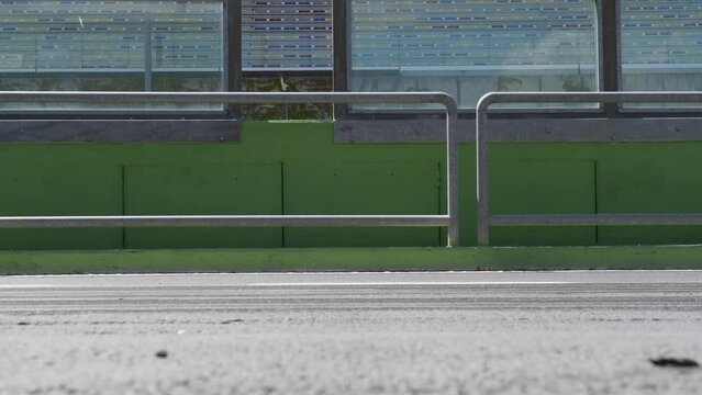 Formula cars racing blur at motorsport track side view from pit lane, original engine sound