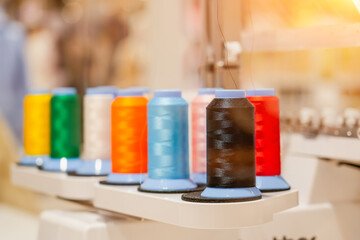 spools of colored thread installed on an automatic digital sewing machine