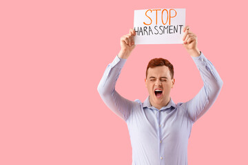 Shouting businessman holding paper with text STOP HARASSMENT on pink background - obrazy, fototapety, plakaty