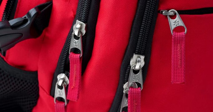 zippers on a red backpack close-up