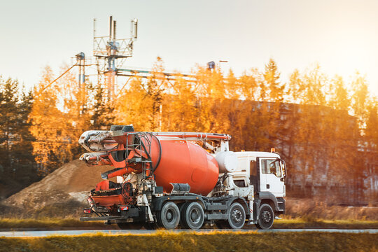 Construction machinery. A Cement mixer truck is delivering liquid concrete to the construction site