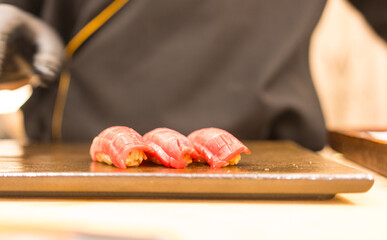 Chef is making perfect tuna sushi in Japanese Omakase in the restaurant
