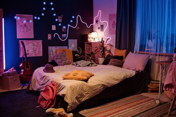 No people wide interior shot of modern teen girls bedroom decorated with neon lights and posters,...