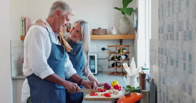 Old couple, cooking and vegetables in kitchen or together for healthy eating or dinner, bonding or nutrition. Man, woman and raw ingredients on board with conversation for wellness, meal prep or diet