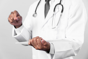 Close up of skilled doctor hands holding application form while pointing at medical data diagnosis. Professional doctor wearing stethoscope and lab coat while standing and looking form. Deviation.