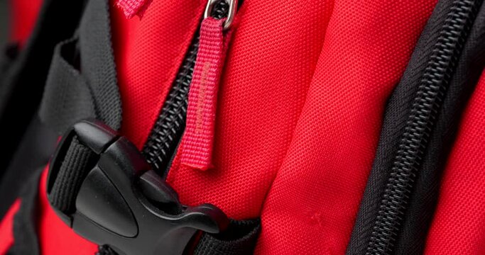 zippers on a red backpack close-up
