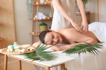 Obraz na płótnie Canvas Beautiful young woman getting back massage in spa salon
