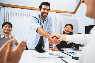 Diverse group of office employee worker shake hand after making agreement on strategic business...