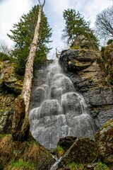 Spring snow melting in the waterfall. National Natural Monument Waterfall of Bystre is located on the southern slopes of Polana, near of Hrinova. © Ivan