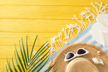 Sunny day essentials: top view of straw hat, sunglasses, slippers, beach blanket, palm leaf,...