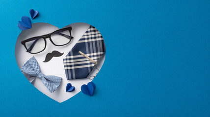 A creative heart-shaped Father's Day display featuring a bow tie, glasses, mustache, and pen...
