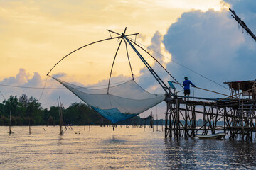 Yor Yak or Thai giant fishing gear with golden morning light, and beautiful sunrise scenery at...