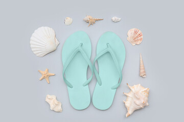 Stylish turquoise flip-flops with seashells on white background