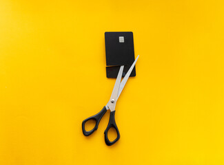 scissors cut a black credit card, finance concept