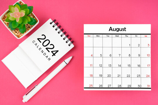 White calendar for August 2024 and pen on pink color background.