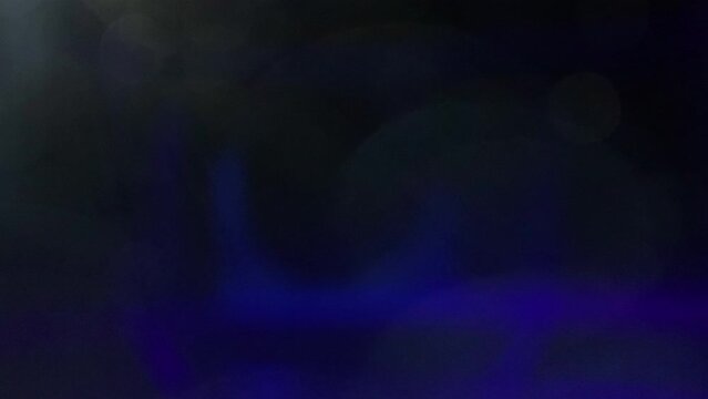 Blue lens light leak transition overlay on black background 