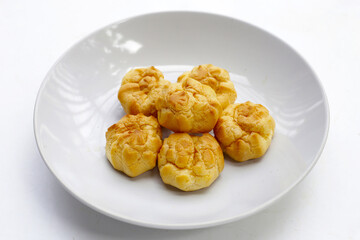 Cream puffs on white plate