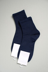 Mens new socks on a gray background, close-up. Cotton socks with blank label - 796279821