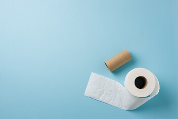Top view of toilet paper roll on blue background