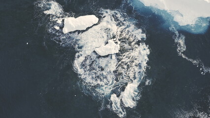 Icebergs Among Antarctica Ocean. Top Down Aerial Flight Over Ice Cold Polar Water. Zooming Out Of...