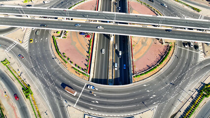 This aerial perspective unveils an interchange roundabout with a tunnel harmoniously nestled into...
