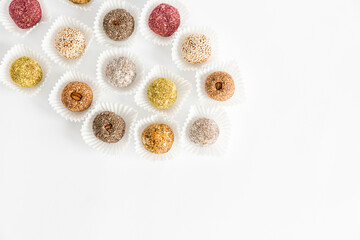 Box of healthy sweets, candies made from natural ingredients. Vegetarian organic food. White background, top view