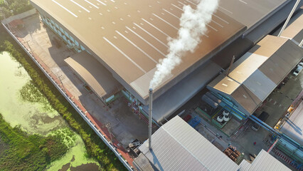 A grim sight, the industrial facility released a constant plume of white smoke, raising questions about its impact on air quality and health. Aerial view drone. Pollution and environment concept.
