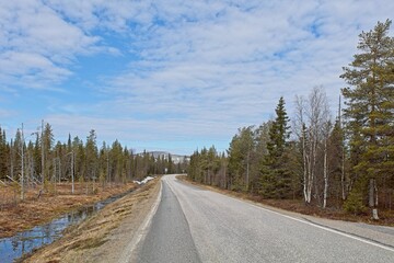 Fototapeta na wymiar Pyhä-luostontie road in cloudy spring weather, Lapland, Finland.