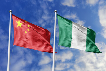 3d illustration. China and Nigeria Flag waving in sky. High detailed waving flag. 3D render. Waving in sky. Flags fluttered in the cloudy sky.
