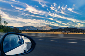 Traveling by car by road. Rearview mirror.