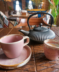 Kettle and cup on table