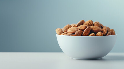 A minimalist composition featuring a white matte ceramic bowl filled with nutritious almonds. Set against a clean white background, this simple yet elegant presentation accentuates the natural beauty 