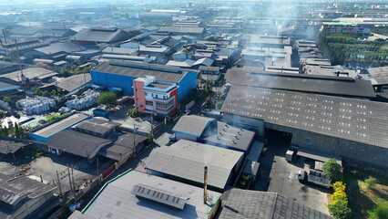 Aerial view drone captures industrial estates releasing smoky plumes into the sky, a haunting...