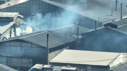 Aerial drones reveal industrial estates spewing smoke, illustrating the environmental impact of...