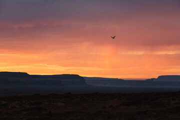 Orange clouds and rainfalls in the desert of Monument Valley, Utah