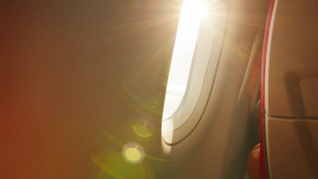 Sun shining through the airplane window during flight