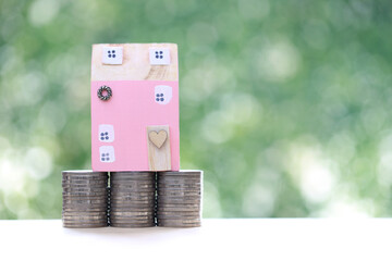 Mortgage,Model house and stack of coins money on natural green background,Business investment and...