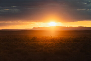 Sunrise in the desert fields of the Monument Valley, Utah