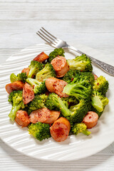 fried juicy sausage and crispy broccoli on plate