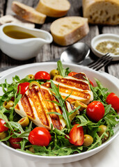 salad with grilled halloumi greek cheese in bowl