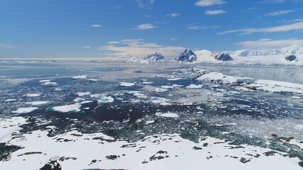 Arctic Polar Mountain Coast Slowmotion Aerial View. Snow Covered Antarctica Ocean Landscape...
