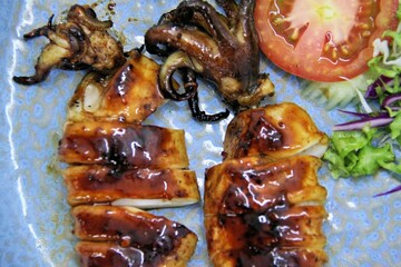 Grilled squids or 'Cumi Bakar' is a sweet and tangy seafood dish that is often sold as street food...