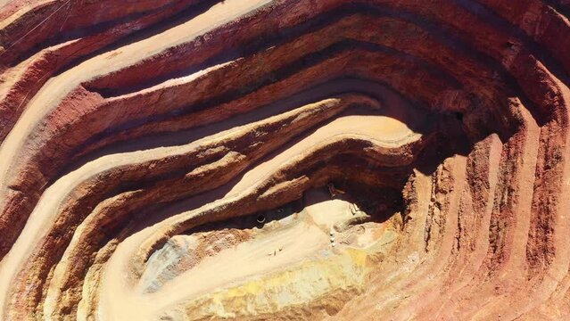 Over deep open pit copper mine in Cobar town of Australia &ndash; aerial industrial view 4k.
