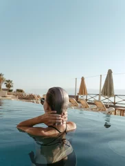 Happy woman enjoying the sun and water at the pool. Lifestyle and summer concept © Rafa