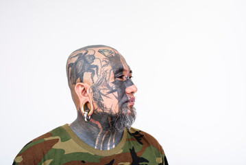 Side view of an asian man with face tattoos - including a cricket, snake and diamond - eye tattoo,...