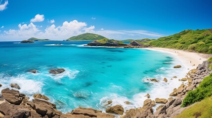 Fototapeta premium a blue water with rocks and a sandy beach
