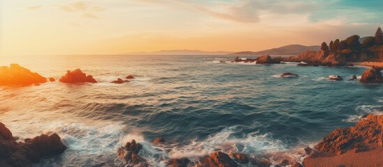 Obraz premium Sunset over rocky beach