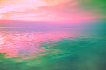 Seascape in the early morning. Calm sea at dawn with beautiful sky. Artistic pink green gradient...